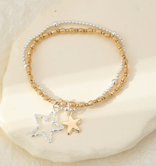Silver and gold plated star charms on double layer bracelet stack with stretch