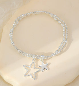 Silver plated star charms sit on a double layer stretch bracelet