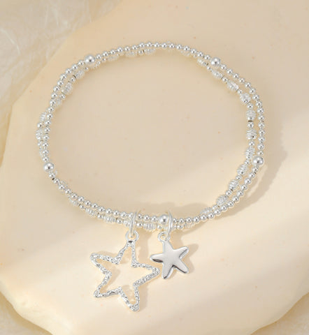 Silver plated star charms sit on a double layer stretch bracelet