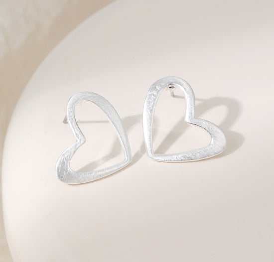 Heart-shaped silver plated earrings on a stud post