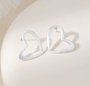 Heart-shaped silver plated earrings on a stud post
