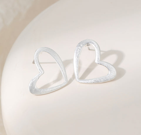 Heart-shaped silver plated earrings on a stud post
