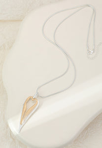 Long necklace with a gold and silver plated heart pendant