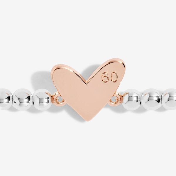 Close-up image of the 60th Birthday bracelet's golden heart-shaped charm.